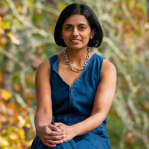 Vidya sitting in a blue dress.